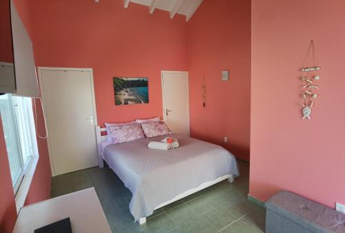 拉贡Apartment Lagoon Ocean Resort的一间拥有红色墙壁的卧室和一张位于客房内的床