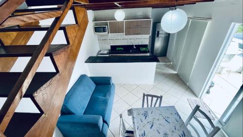 邦比尼亚斯Residencial Morro Macaco Apartamentos的一间带楼梯和蓝色沙发的小厨房