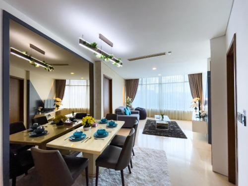 吉隆坡Vortex Suites KLCC by Nadia Guesthouse Kuala Lumpur的用餐室以及带桌椅的起居室。