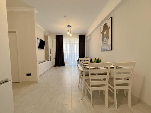 基希讷乌OASIS, Charming 1BD apartment with living room的用餐室以及带桌椅的起居室。