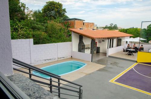 圣若昂-德雷Studio 900m do centro, prédio com piscina, sauna, academia e lavanderia的一座带游泳池和篮球场的房子
