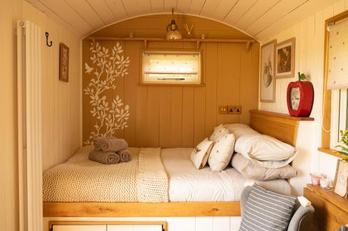 Pen y ClawddHarrys Hideout - Shepherd's Huts at Harrys Cottages的一间小房间的卧室,配有一张床铺