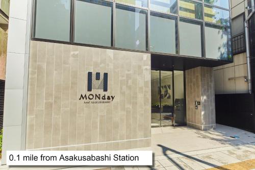 东京hotel MONday Akihabara Asakusabashi的建筑的侧面有公司标志