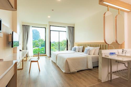 奥南海滩Infinity Aonang Krabi - SHA Certified的酒店客房设有床和水槽