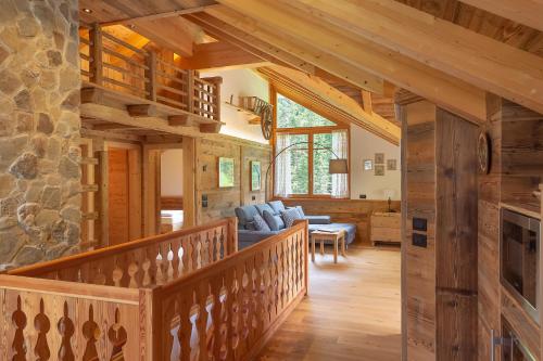 圣马蒂诺-因巴迪亚Chalet Mornà的小木屋内带木制楼梯的客厅
