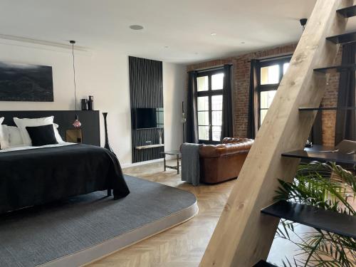 佩皮尼昂Ennéa - Jacuzzi & Luxury Suites的一间卧室设有一张床和一间客厅。