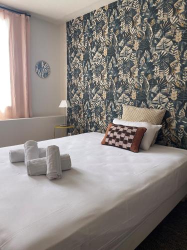 莫吉奥Hôtel Clair de Lune的卧室里一张带两条毛巾的床