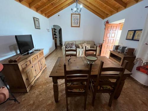 阿古洛Casa Rural Quilla的客厅配有木桌和电视。