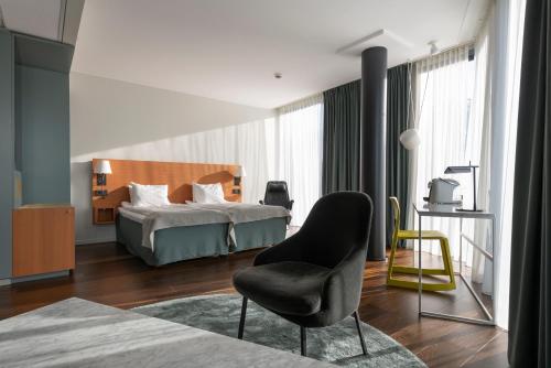 斯德哥尔摩品质环球酒店的一间卧室配有一张床和一把椅子
