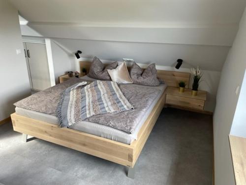 蒙绍Zimmermanns 2的一间卧室配有一张带枕头的大型木制床。