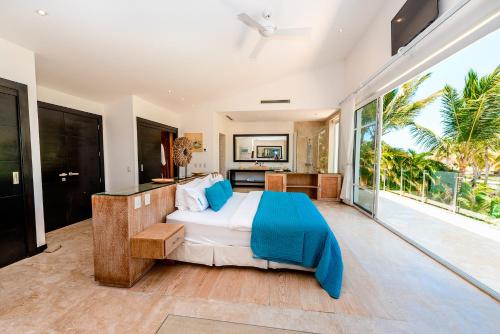 蓬塔卡纳Luxury Villa Waterfall with Private Pool, BBQ & Maid的一间卧室设有一张床和一个大窗户
