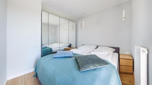 萨比诺瓦Apartamenty Sun & Snow BLUE II的一间卧室配有一张床和一面大镜子