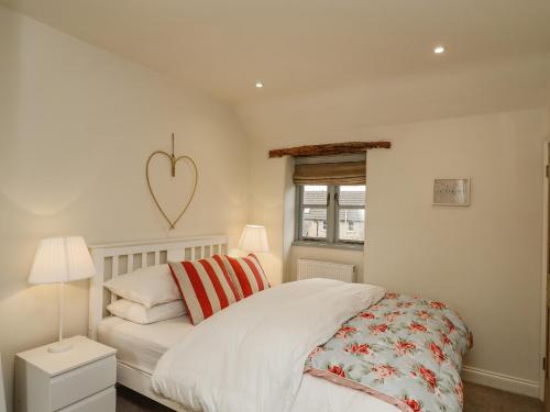 奥克姆Pheasant Cottage的卧室配有一张位于墙上的床铺。