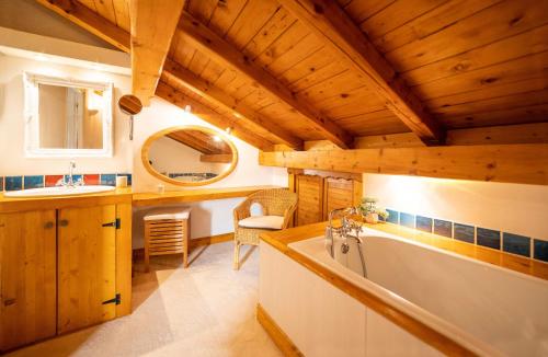 谷雪维尔Magnifique chalet authentique au cœur des 3 vallées的客房内设有带水槽和浴缸的浴室