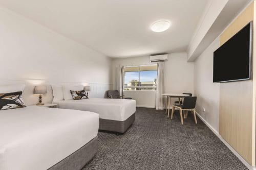 达尔文达尔文旅程住宿酒店的酒店客房设有两张床和一台平面电视。