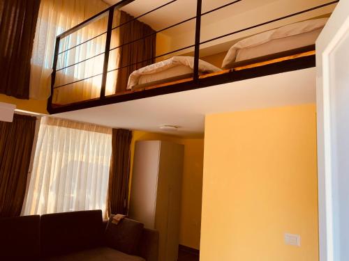 地拉那Auto Tana Guest House的客房设有两张双层床和一张沙发。