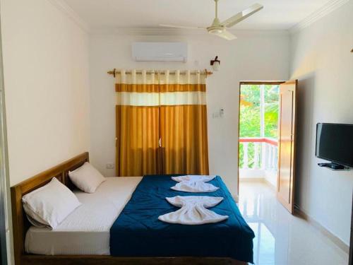 米瑞莎Mirissa Village MIRISSA的一间卧室配有一张床,上面有两条毛巾