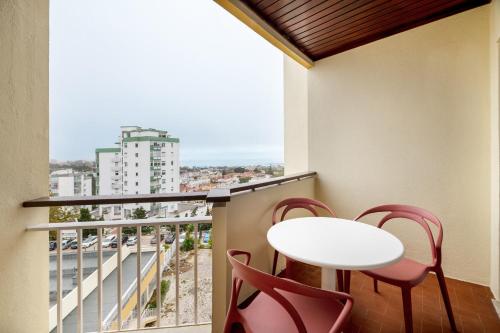 卡斯卡伊斯Equador Superior Suites by Olala Homes的阳台配有白色的桌椅和窗户。