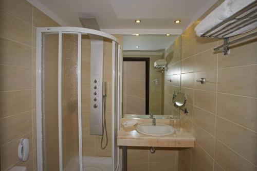 罗希姆诺奥林匹克一号酒店的一间带水槽和淋浴的浴室