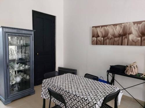 鲁贝Chambres privatives avec espaces partagés dans maison Roubaix centre的一间配备有桌子和黑色橱柜的用餐室