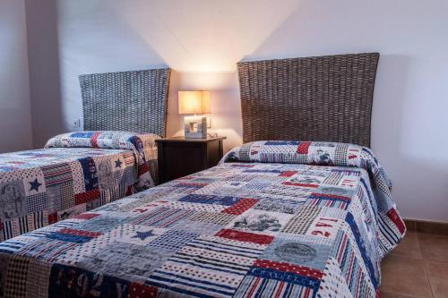 蒂亚斯CASA MORRO BLANCO的一间卧室配有两张床和被子