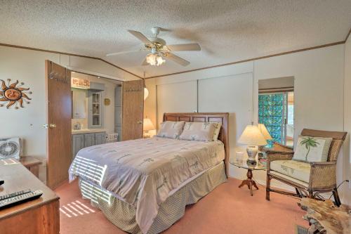 Birch TownQuaint Chincoteague Island Hideaway with 2 Porches!的一间卧室配有一张带吊扇和椅子的床