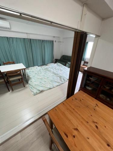 东京G&R House302的小房间设有一张床和一张桌子