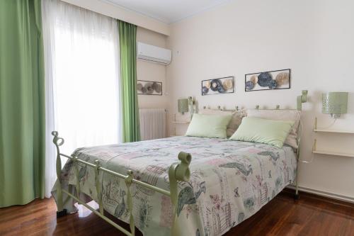雅典Ioanna's Hellenic Hospitality的一间卧室配有一张带绿色窗帘的床和窗户。
