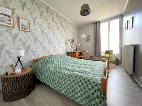 兰斯Le Neufchâtel appartement cosy 3 chambres的一间卧室配有一张带绿毯的床