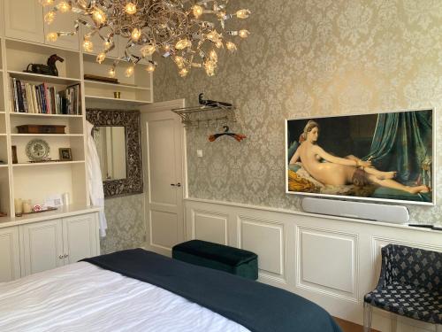 哈莱姆GuesthouseOne的一间卧室配有一张床,墙上配有电视