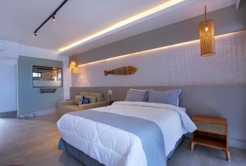 乌巴图巴恩赛亚达村酒店的卧室配有一张白色的大床和一张沙发。