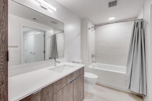 华盛顿Global Luxury Suites at Capitol Hill的一间带水槽、浴缸和卫生间的浴室