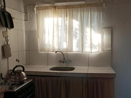 巴拉德瓦利扎斯Casa Vapahí的带水槽的厨房台面和窗户