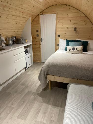 BurnfootThe Burrow - Sleeps 4的一间卧室设有一张大床和木制天花板