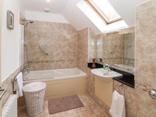 肯梅尔Ring of Kerry Golf Club Cottage的带浴缸和盥洗盆的浴室