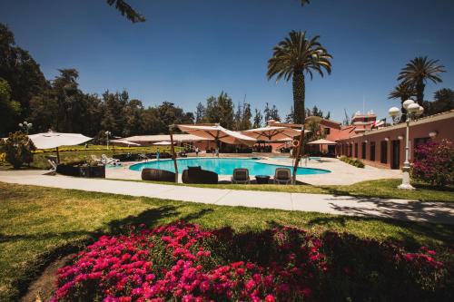 阿雷基帕Wyndham Costa del Sol Arequipa的一个带粉红色花卉游泳池的度假酒店