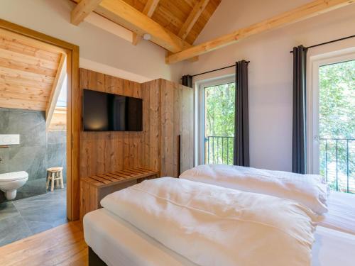 穆劳附近圣洛伦岑Mountain Chalet Alpinchique的配有电视和浴室的客房内的两张床