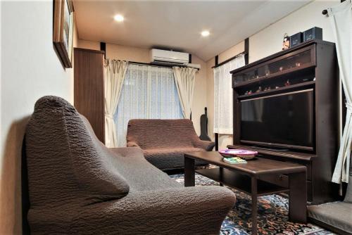 东京Homestay Intimo Amigo的带沙发和电视的客厅