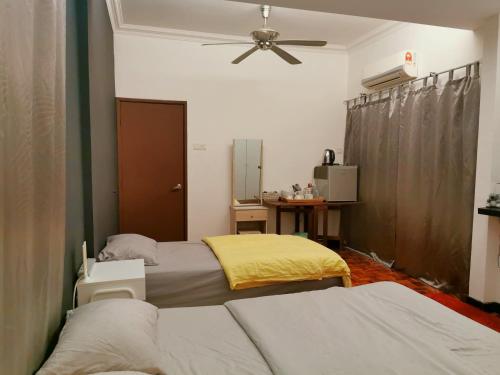 梳邦再也D2Pie Homestay的一间卧室配有两张床和吊扇