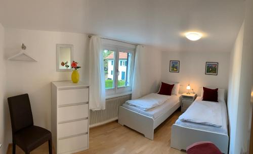 布雷根茨Chalet zum See的一间卧室设有两张床和窗户。