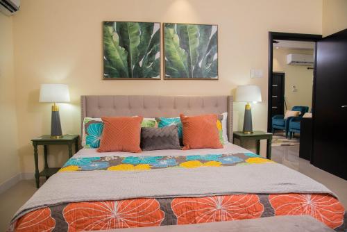 欧丘里欧Hey Love的一间卧室配有一张带橙色枕头的大床