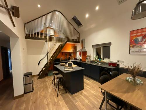 卡斯尔敦贝尔Wild Wild West Holiday Cottages的厨房和带螺旋楼梯的用餐室