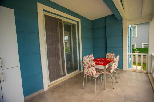 萨潘贾Antonelya Home的一间用餐室,配有红色的桌子和椅子