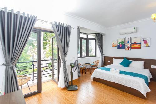 Văn LâmBlue Eyes Hotel的一间卧室设有一张床和一个阳台