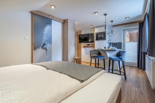 索尔登Garni Ötztal ROOMS & APARTS的一间带大床的卧室和一间厨房