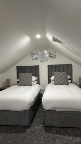 HordenBelsay 4 bedroom bungalow with loft conversion的一间卧室配有两张单人床。