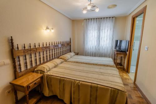桑托多明戈德锡洛斯桑托多明戈德西洛斯旅馆的一间卧室配有两张床和电视。