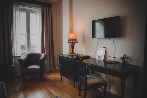 厄勒布鲁Mojo Hotell的客房配有带台灯和椅子的书桌
