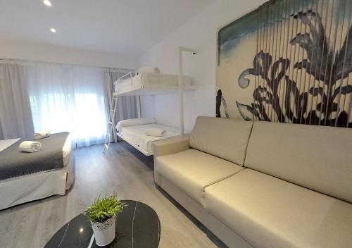 塞维利亚ISA Sevilla Suites的客厅配有沙发和1张床