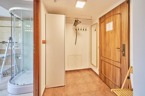 霍尔马拉帕Apartment Eskadra的带淋浴的浴室和玻璃门